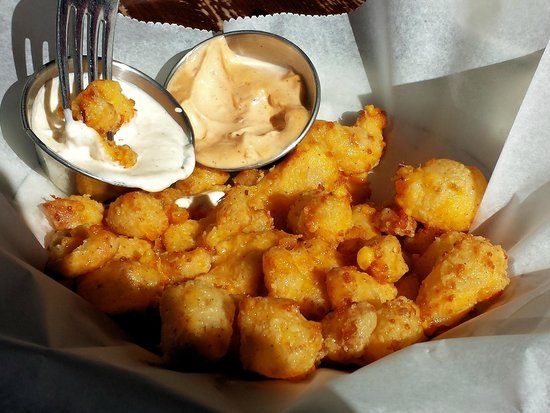 The Old Fashioned Madison signature dishes Beer Battered Cheese Curds, The #1 Brat (Usinger's), Friday Fish Fry, various Wisconsin cheese boards, The Old Fashioned cocktail (many variations).
